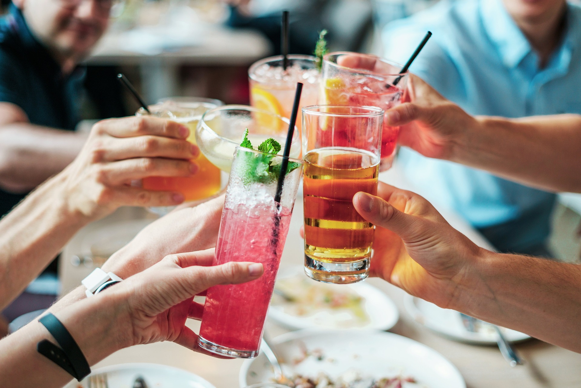 Friends raising colorful party drinks