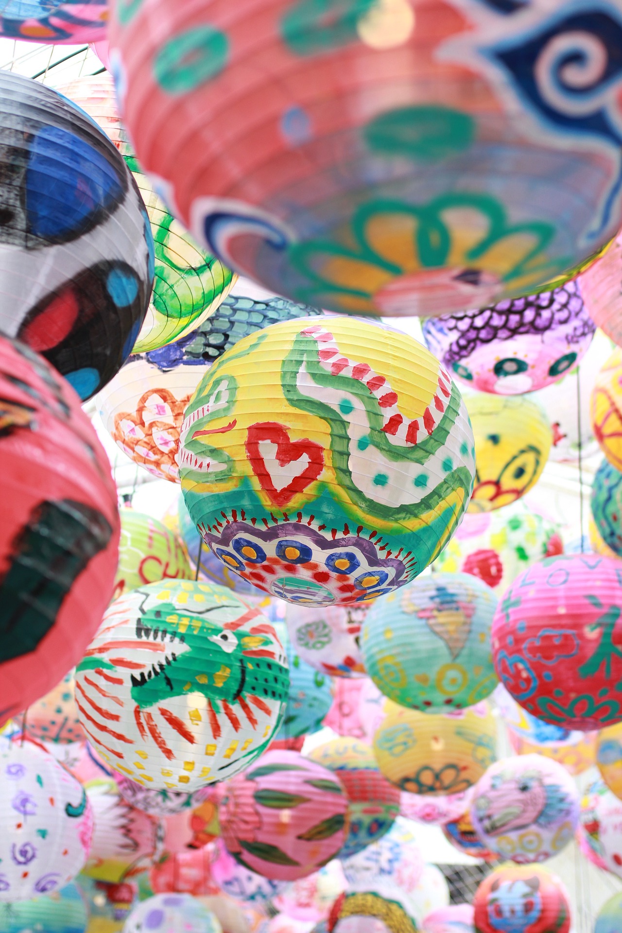 A colorful display of painted party lanterns
